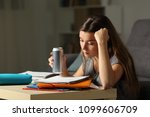 Student preparing exam memorizing notes holding and energy drink in the night at home