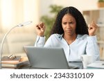 Confused freelancer checking laptop online content tele working at home
