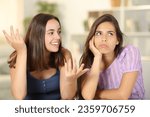 Woman ignoring the conversation of her friend at home