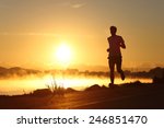 Silhouette Of A Man Running At...