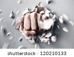 Small photo of a wall is broken through by a fist