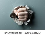 Small photo of a wall is broken through by a fist