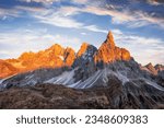 Small photo of Pale di San Martino mountain group in sunset time. Hight mountains with glacier glowing by sunset light. San Martino di Castrozza, Dolomites, Trentino, Italy