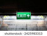 exit sign light In front of the stairs.