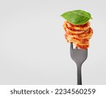 Pasta with tomato sauce on a fork