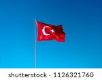 Turkish Flag Waving In Blue Sky.