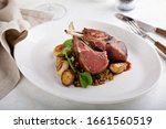 Roasted rack of lamb with baby potatoes on a plate