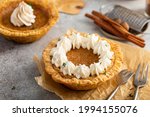 Mini sweet potato pies, warm and spicy fall dessert topped with whipped cream