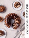 Small photo of Chocolate marble bundt cake or zebra cake with chocolate glaze sliced overhead view