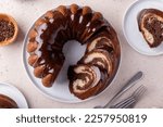 Chocolate marble bundt cake or zebra cake with chocolate glaze sliced overhead view