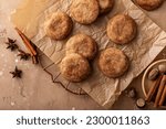 Small photo of Cinnamon cookies tossed with cinnamon sugar on a parchment paper with milk, classic snickerdoodle cookies