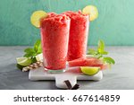 Watermelon slushie with lime, summer refreshing drink in tall glasses