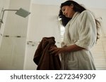 Young woman standing in bathroom after morning shower