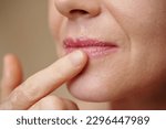 Small photo of Closeup image of woman scrubbing lips to get rid of dead skin cells