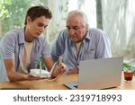 Small photo of Young man setting wi-fi router to establish internet connection for grandfather