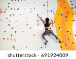 Woman Climbing On The Wall ...