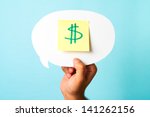 Finding the right investment opportunity, social media budget, pricing. Green dollar money sign symbol on stick-note over speech bubble and blue background.