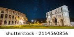 Colosseum (Coliseum) in Rome (Roma), Italy and Arch of Constantine at night. Panorama of Flavian Amphitheatre and Arco de Constantino