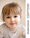 Small photo of cute smiling child girl with blonde hair and quiff closeup portrait