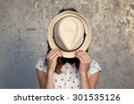 Young girl with hat. Hides her face.Depression.Photo tinted and styled with vintage photo.