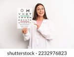 pretty woman looking excited and surprised pointing to the side. optical vision test concept