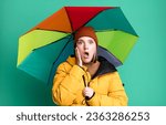 Small photo of young pretty woman wearing an anorak and a umbrella