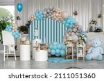 Small photo of Happy Birthday! Children's decoration with glowing lights, birthday garland, different color of balloons. Decorated photo zone. Festive decorative elements, photo area