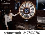 Small photo of Skopje, North Macedonia - 13 February 2023: Wheel of fortune. Colorful casino game cabinet slot machine flashing lights. game spinning light with bankrupt, success and fresh start slots