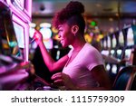 Happy woman gambling at casino...
