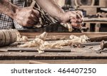 carpenter working with plane on wooden background
