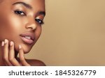 Small photo of Beauty portrait of African American girl . Beautiful black woman touch her face . Facial treatment . Cosmetology , skin care and spa .