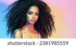 Small photo of Beauty portrait of african american woman with afro wavy hairstyle . Smiling dreamy beautiful girl. Curly black hair Portrait with color filters. Cosmetology , beauty and spa