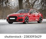 Modern red car, sportcar driving on the road,  city car background