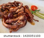 Small photo of Octopus grill with onion, garlic, capper. Baked octopus with rosemary, onion, olives, capper and lemon. Maltese food