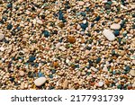 Abstract nature pebbles background. Multicolored wet pebbles on the Mediterranean beach.