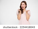 Small photo of Happy Asian woman presenting or showing open hand palm with copy space for product isolated over white background