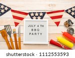July 4th BBQ Party sign on a white mamo board.