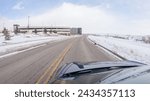Small photo of Centennial, Colorado, USA-January 30, 2023-Navigating a frontage road post-winter storm offers a serene drive. The surrounding landscape, blanketed in snow, contributes to the peaceful and picturesque