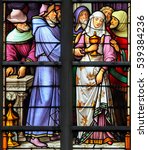 Small photo of BRUSSELS, BELGIUM - JULY 26, 2012: Stained Glass depicting the antisemitic legend of desecrated hosts, whereby a female Jewish convert to christianity is paid to take stolen hosts to Cologne.