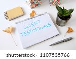 Small photo of client testimonials written in a notebook on white table