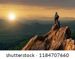 Concept vision, Young businessman wearing comfortable casual suit jacket standing holding business bag on top of peak mountain and looking forwards, success, competition and leader concept.