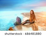 Sea mermaid. Blonde beautiful Siren Mermaid . Mermaid girl with pink tail put feet in water. Top view. Fun, vacation concept.
