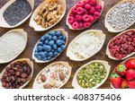 Super food, fruits, berries, nuts, seeds top view on rustic wood background. Detox, superfood concept.