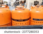 Small photo of Orange Butane and Propane Cylinders Ready for Delivery