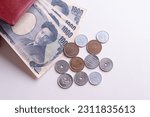 Small photo of Japanese yen notes and Japanese yen coins for money concept background.Japanese Yen banknotes isolated on white background.