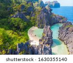 Aerial view of Hidden beach in Matinloc Island, El Nido, Palawan, Philippines - Tour C route - Paradise lagoon and beach in tropical scenery