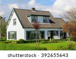 Dutch country house, shutter doors and green front yard garden landscape