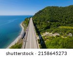 Small photo of The Zubova Schel Viaduct is a road bridge, Dzhubga - Adler federal road. Aerial view of car driving along the winding mountain road in Sochi, Russia.