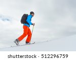 Man alone with ski mountaineering climb towards the summit