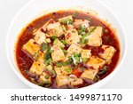 Close up View Asian traditional food Mapo doufu consists of tofu set in spicy sauce, typically a thin, oily, and bright red suspension, based on douban and douchi along with minced beef meat.